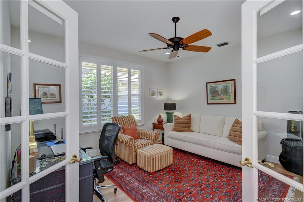 3531 Southeast Cambridge Drive Stuart, FL 34997 - Photo 29 of 44 a living room with furniture and a flat screen tv