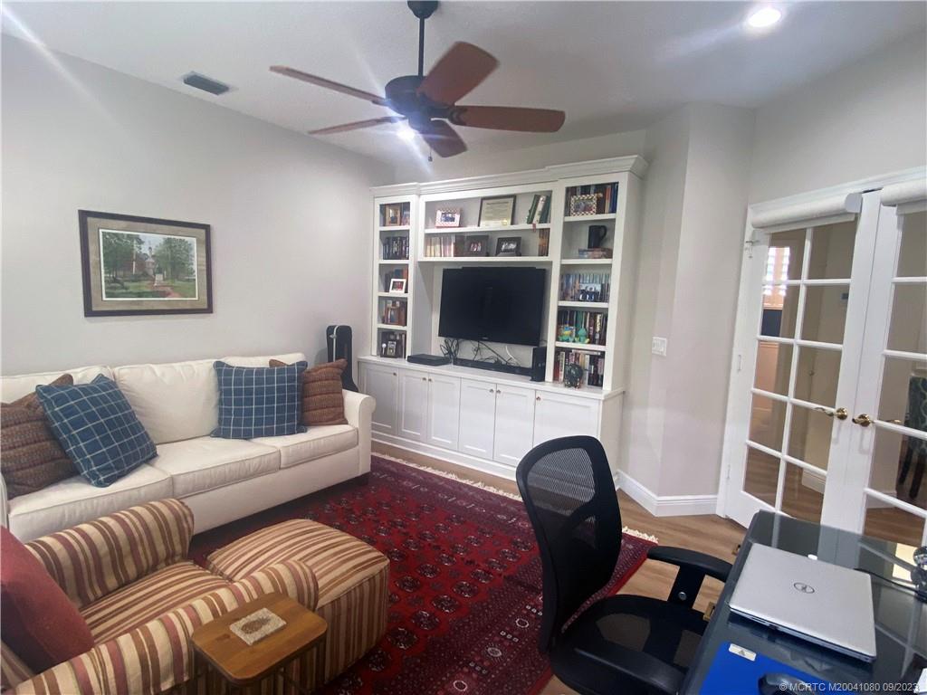 3531 Southeast Cambridge Drive Stuart, FL 34997 - Photo 30 of 44 a living room with furniture and a flat screen tv
