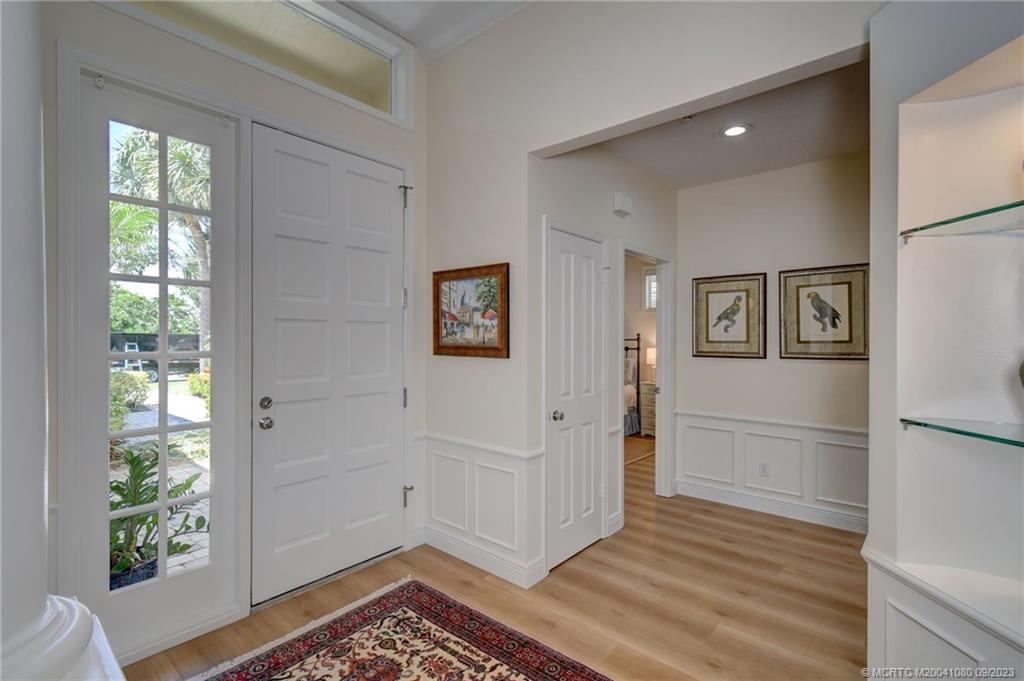 3531 Southeast Cambridge Drive Stuart, FL 34997 - Photo 8 of 44 a view of a hallway with wooden floor and a cabinet