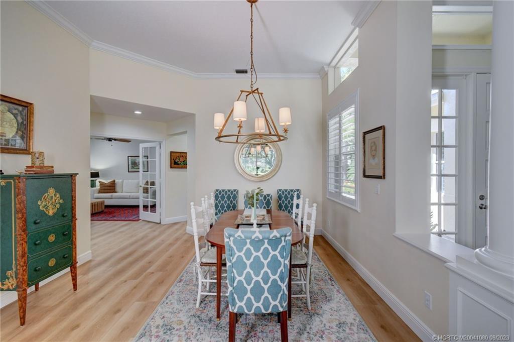 3531 Southeast Cambridge Drive Stuart, FL 34997 - Photo 9 of 44 a living room with furniture a table and a chandelier