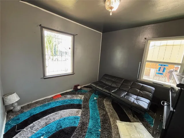 a bed sitting in a bedroom next to a window