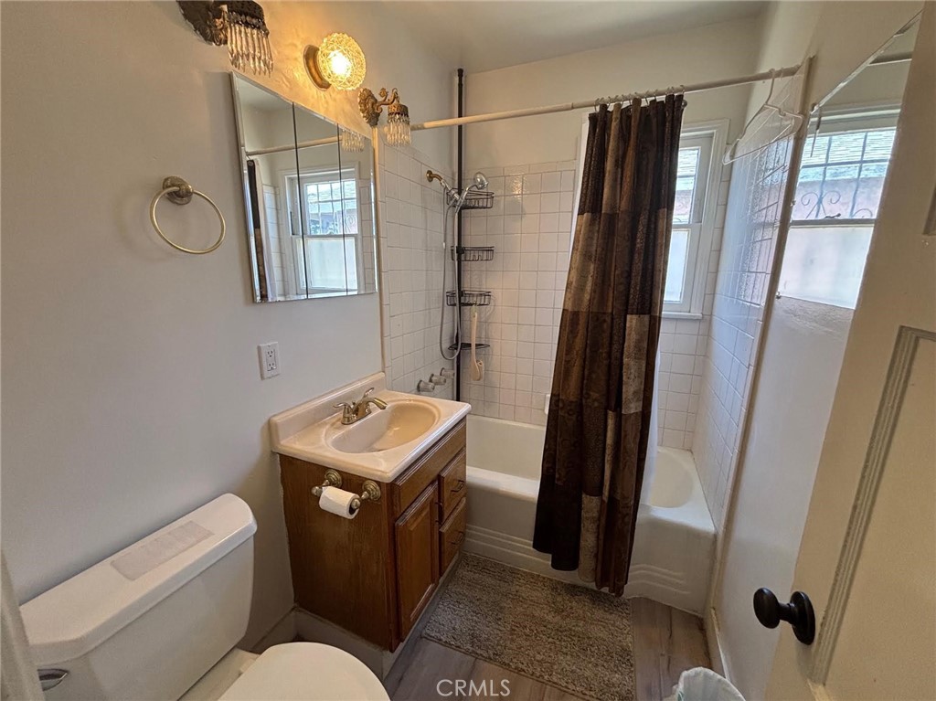 1418 West Magnolia Street Compton, CA 90220 - Photo 5 of 8 a bathroom with a sink toilet and shower