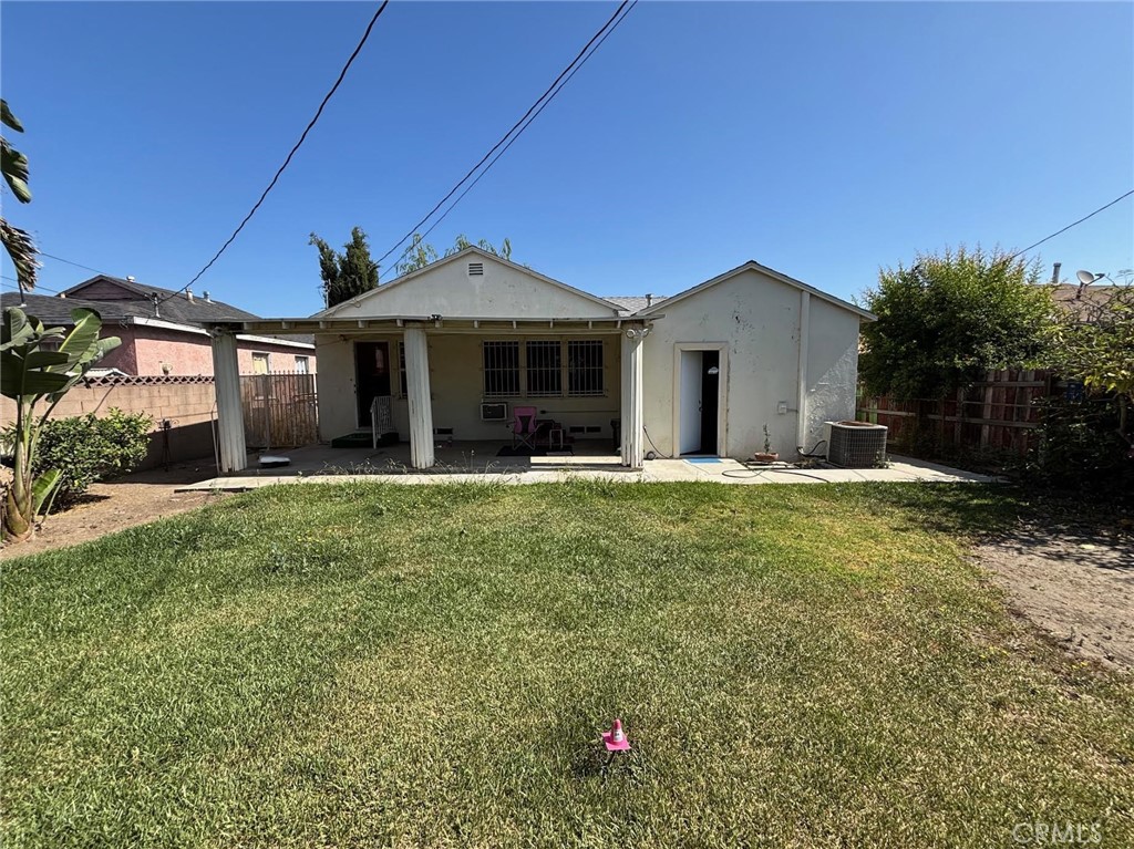 1418 West Magnolia Street Compton, CA 90220 - Photo 7 of 8 a front view of a house with a yard
