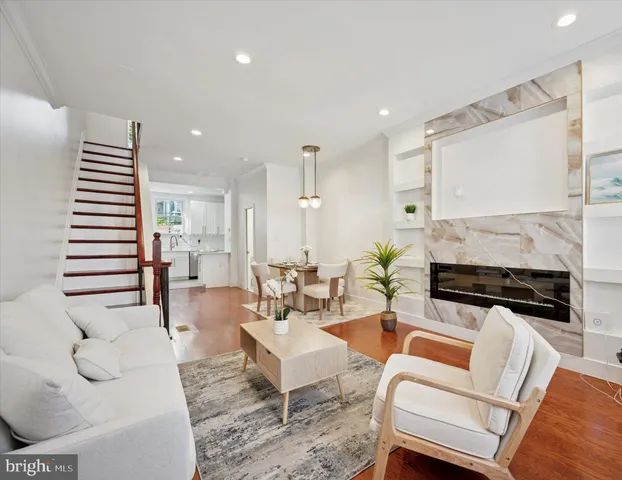 a living room with fireplace furniture and a wooden floor
