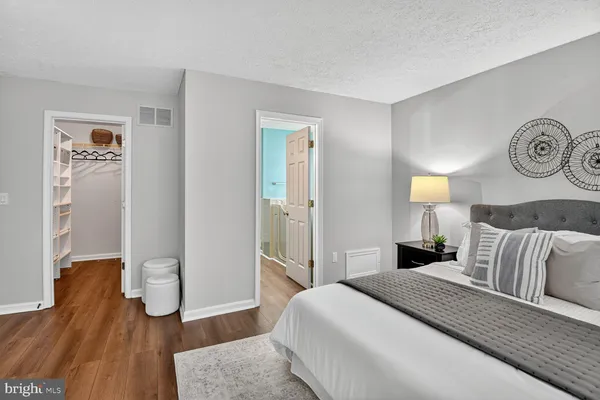 a bedroom with a bed and wooden floor