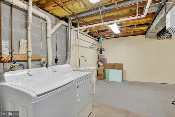 a utility room with a sink a vanity and a window