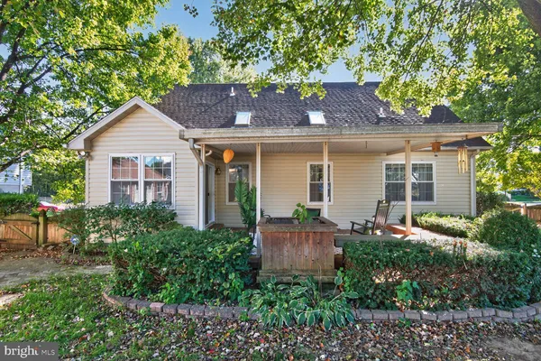 a front view of house with yard and outdoor seating