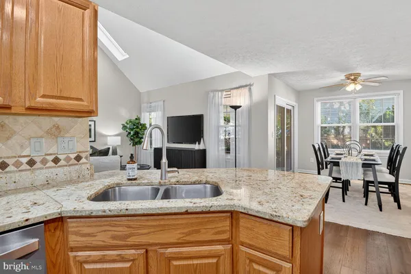 a kitchen with granite countertop a sink and cabinets