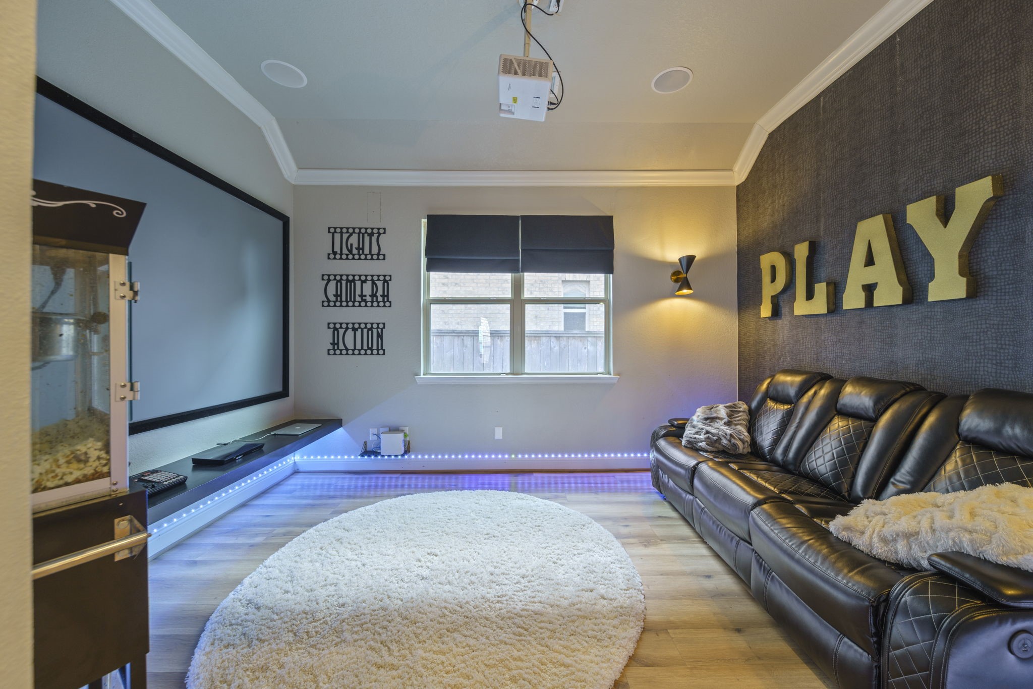 15 Inland Prairie Drive Tomball, TX 77375 - Photo 15 of 46 The media room/game room set off to the right of the kitchen area with a large sliding wooden barn door.
