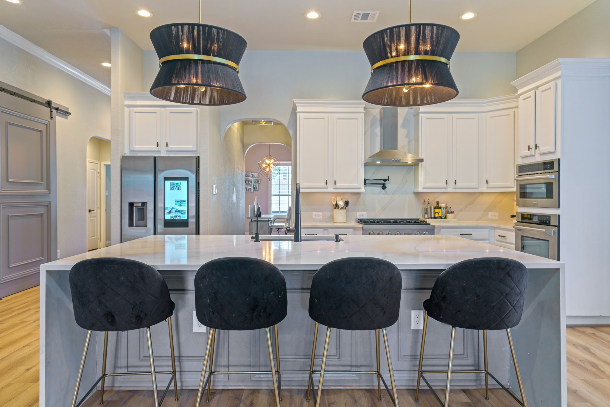 15 Inland Prairie Drive Tomball, TX 77375 - Photo 19 of 46 Another view of the kitchen with updated lighting, plenty of seating and white cabinets.