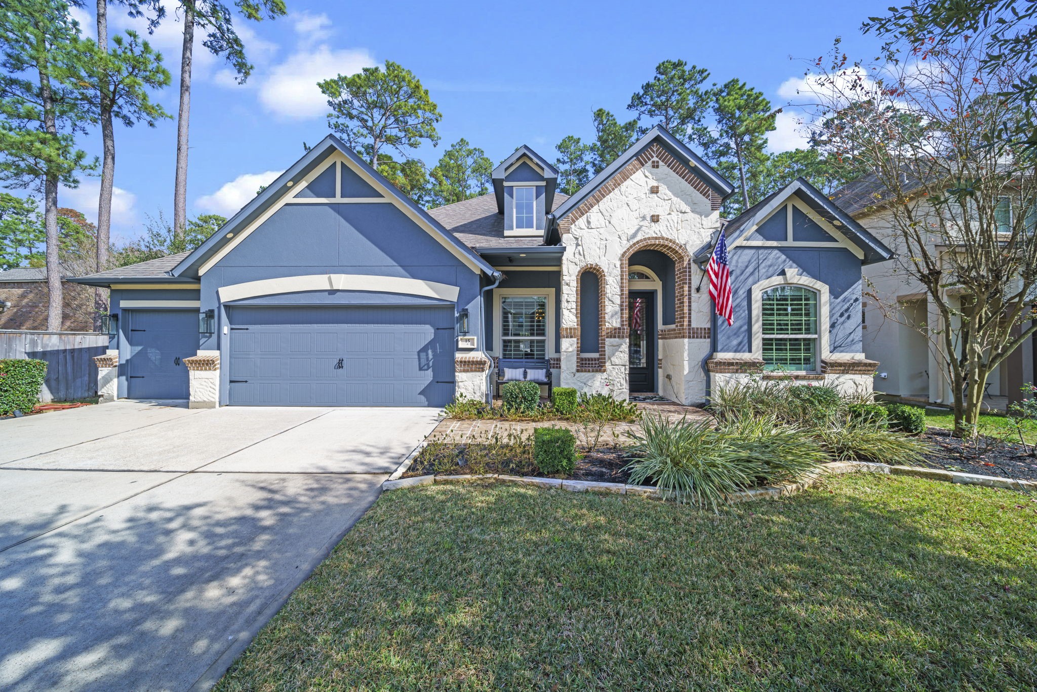 15 Inland Prairie Drive Tomball, TX 77375 - Photo 2 of 46 The front yard is well-maintained with lush landscaping, and large trees provide a serene backdrop.