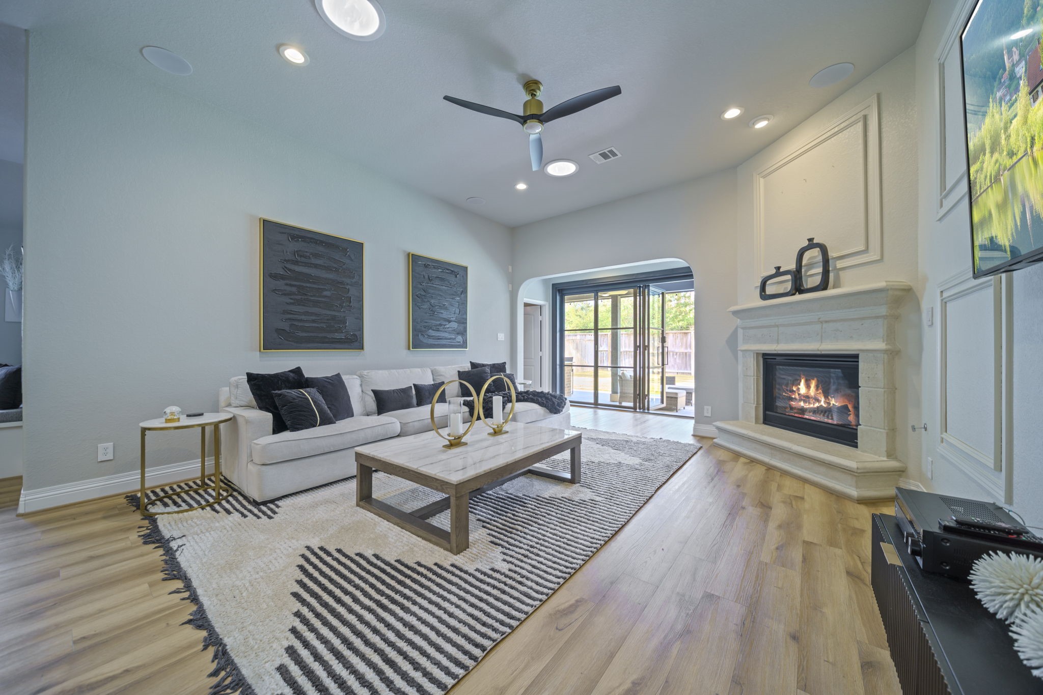 15 Inland Prairie Drive Tomball, TX 77375 - Photo 27 of 46 The living room offers open space, gas fire place, tall ceilings and ample natural light from large sliding doors leading to an outdoor space.