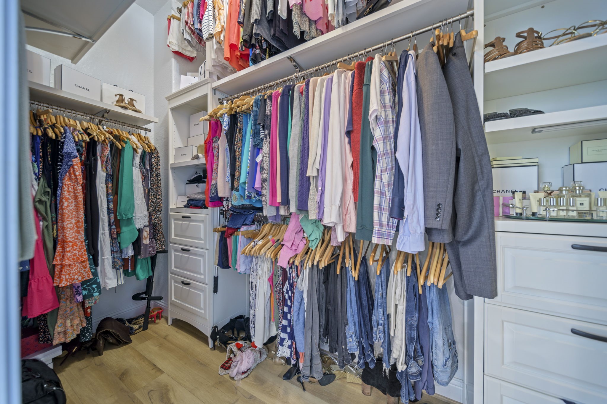 15 Inland Prairie Drive Tomball, TX 77375 - Photo 39 of 46 The primary closet spacious, well-organized walk-in closet with ample hanging space, built-in drawers, and shelving for shoes and accessories. The light wood flooring and bright lighting enhance the room's airy feel.