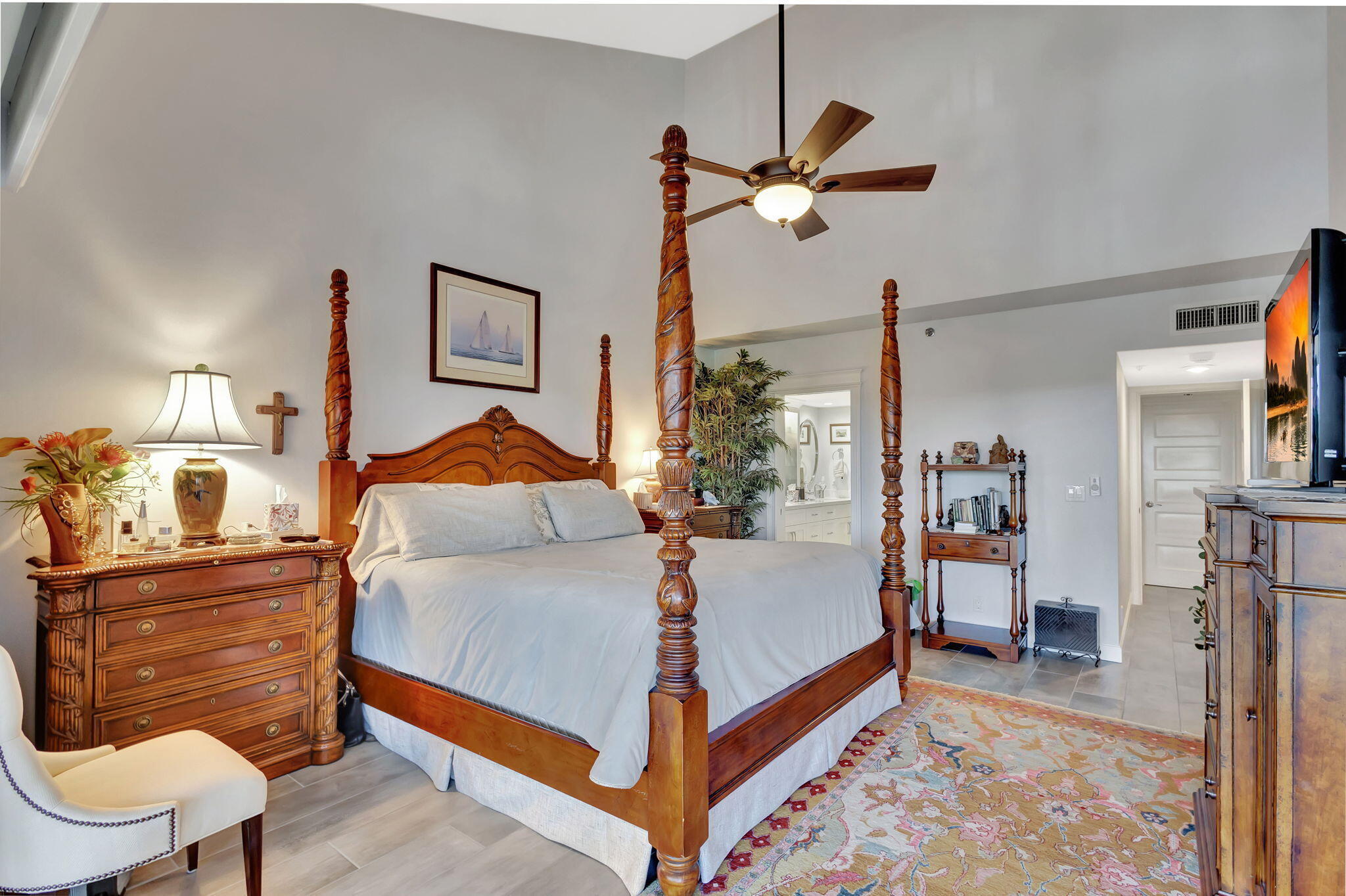 16910 Bay Street, Unit E503 Jupiter, FL 33477 - Photo 12 of 33 a bedroom with a bed and a lamp on dresser