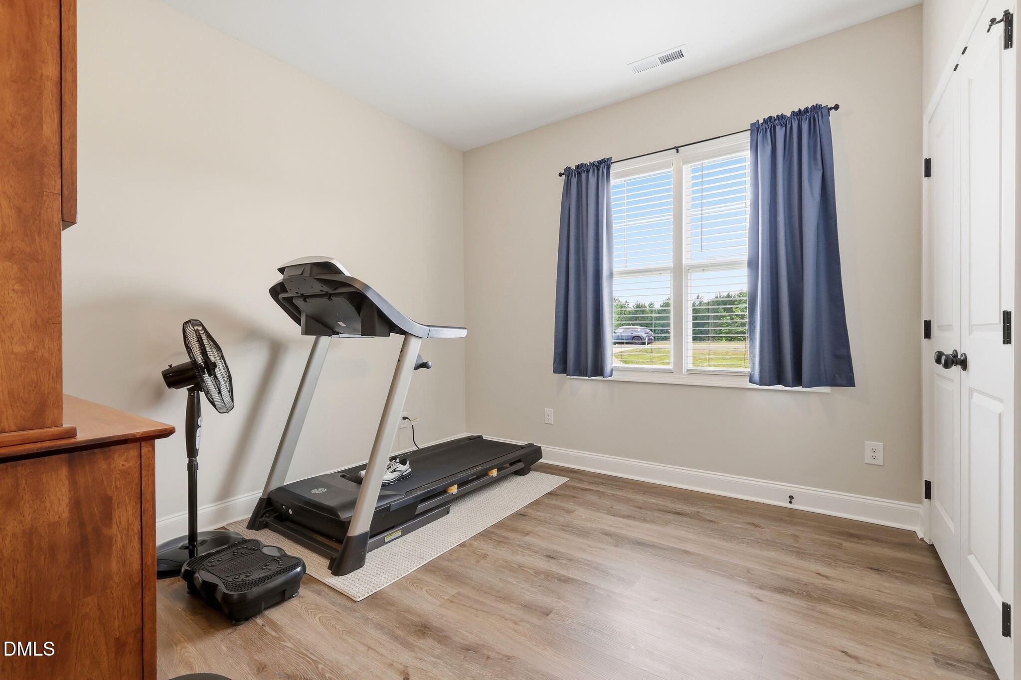 5098 Spring Hill Church Road Lillington, NC 27546 - Photo 19 of 36 a room with gym equipment and a window