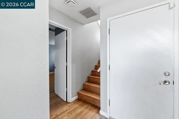 a view of entryway with stairs and wooden floor