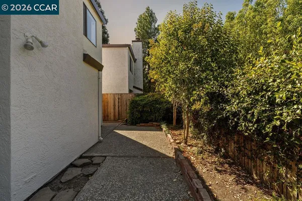 a view of a pathway of a house with a yard