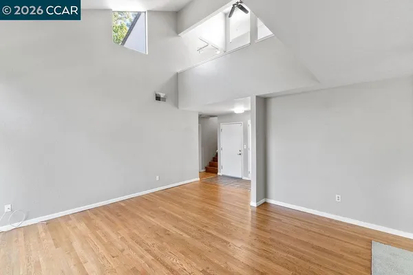 a view of an empty room with wooden floor