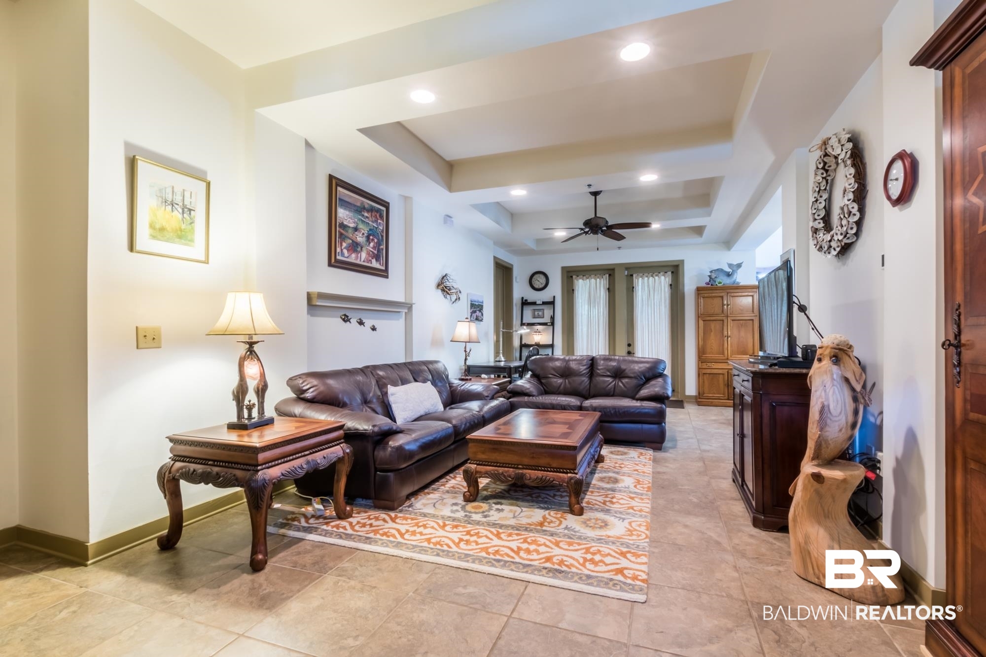 1430 Regency Road, Unit G103 Gulf Shores, AL 36542 - Photo 8 of 29 Tiled living room featuring ceiling fan, a raised ceiling, and french doors