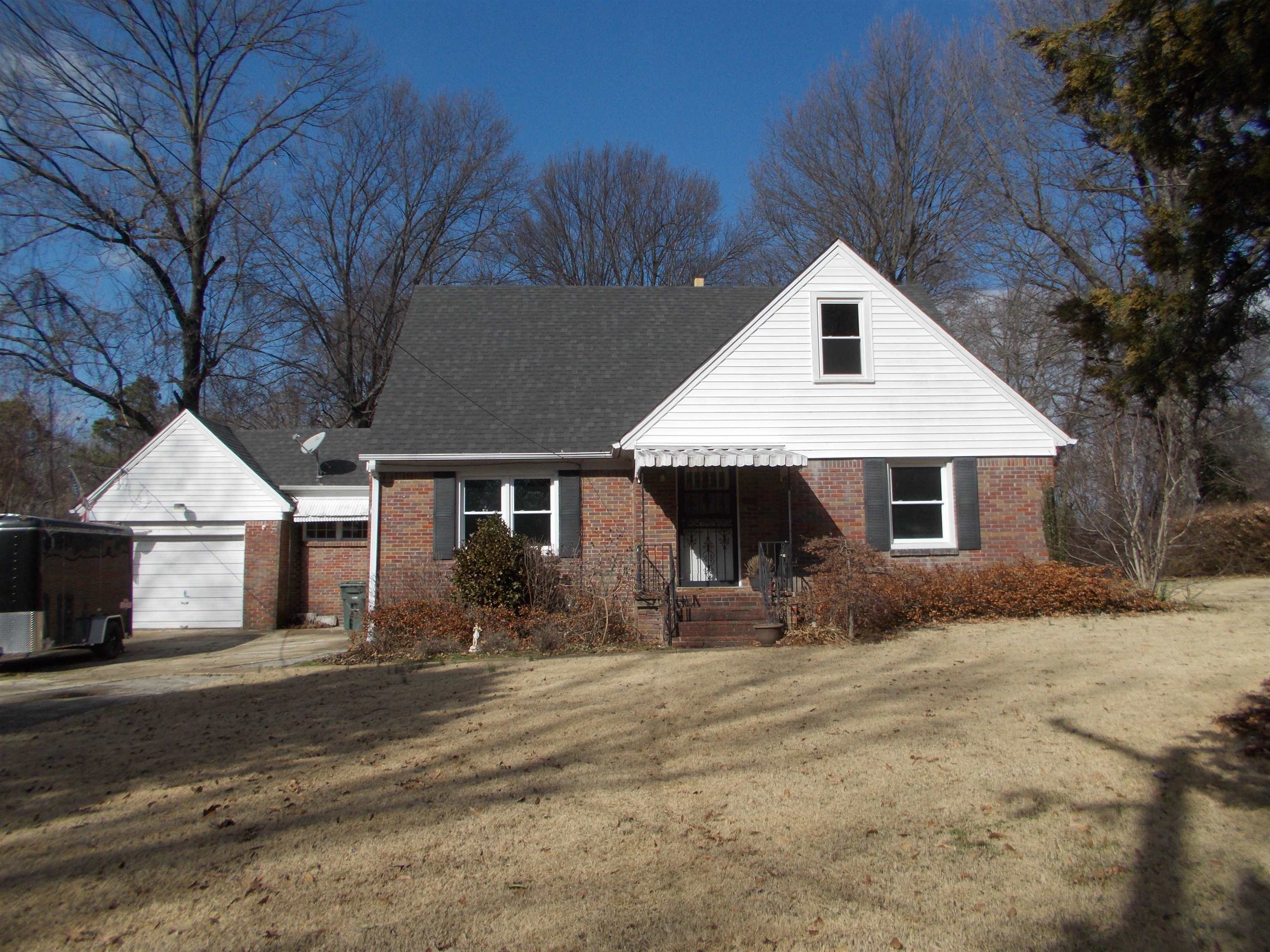 954 North Ball Road Memphis, TN 38106 - Photo 1 of 25 a front view of a house with a yard covered with snow