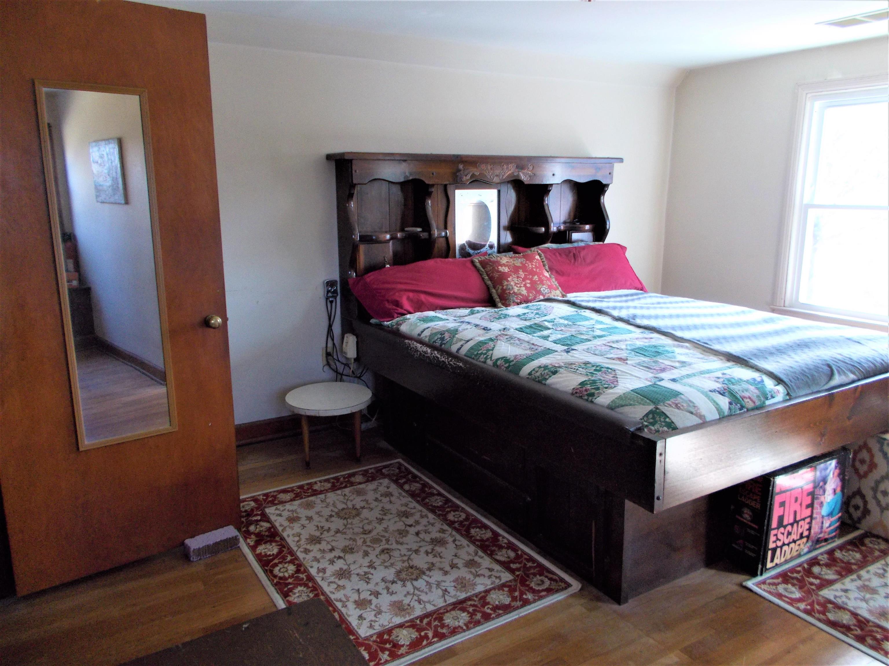954 North Ball Road Memphis, TN 38106 - Photo 16 of 25 a bedroom with a bed and wooden floor