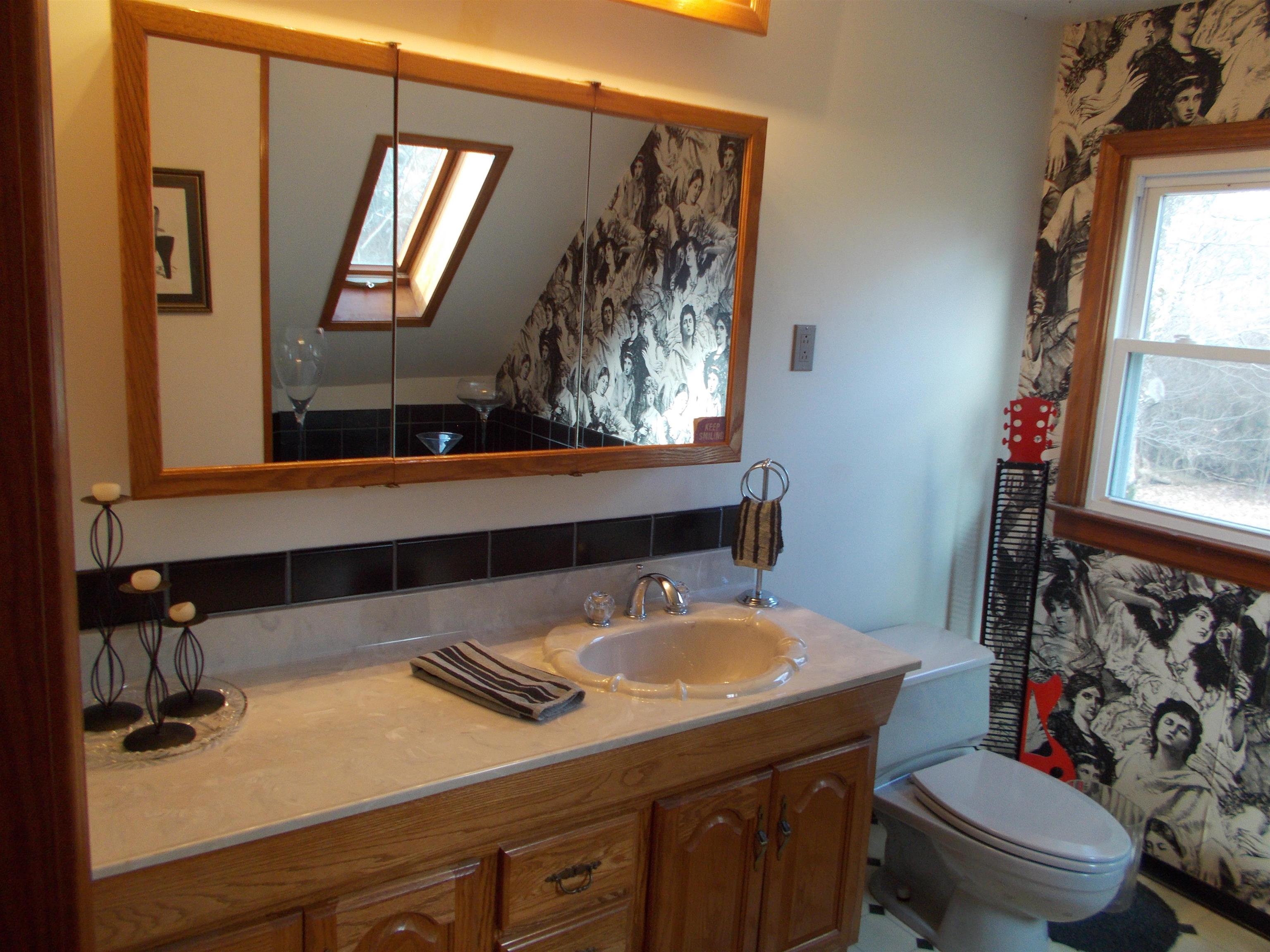 954 North Ball Road Memphis, TN 38106 - Photo 18 of 25 a bathroom with a sink a toilet and mirror