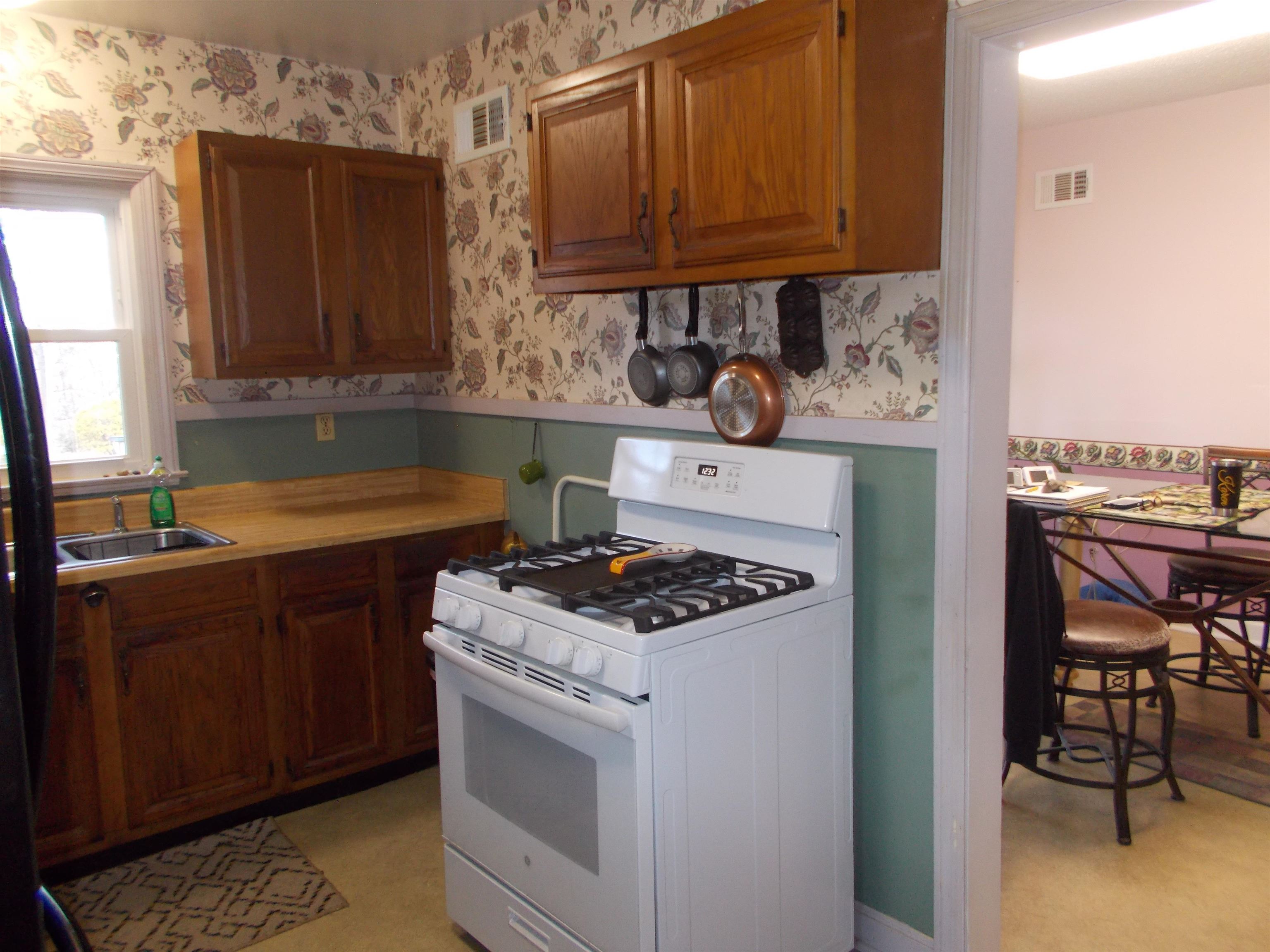 954 North Ball Road Memphis, TN 38106 - Photo 7 of 25 a kitchen with stainless steel appliances granite countertop a stove and a refrigerator