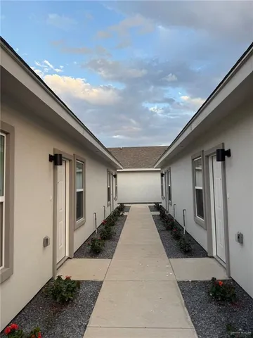 a living room with stainless steel appliances furniture and a chandelier