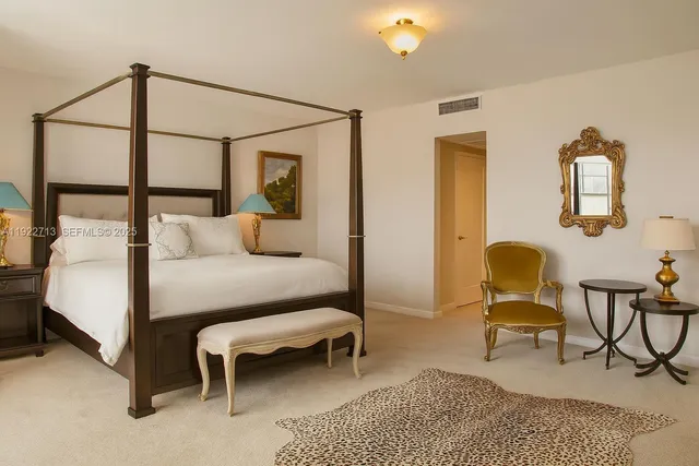 a white bath tub sitting next to a shower