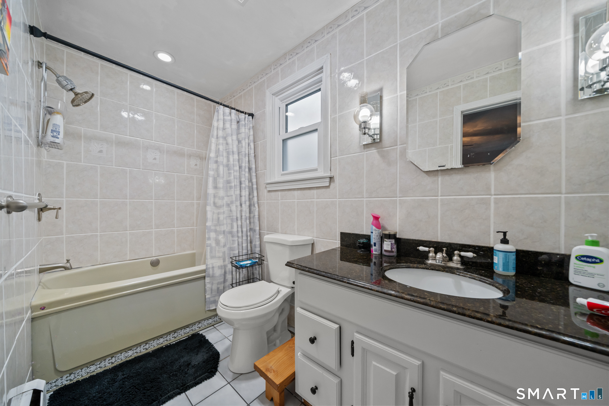 12 Lake Street Ledyard, CT 06339 - Photo 14 of 19 a bathroom with a double sink a toilet a mirror and shower