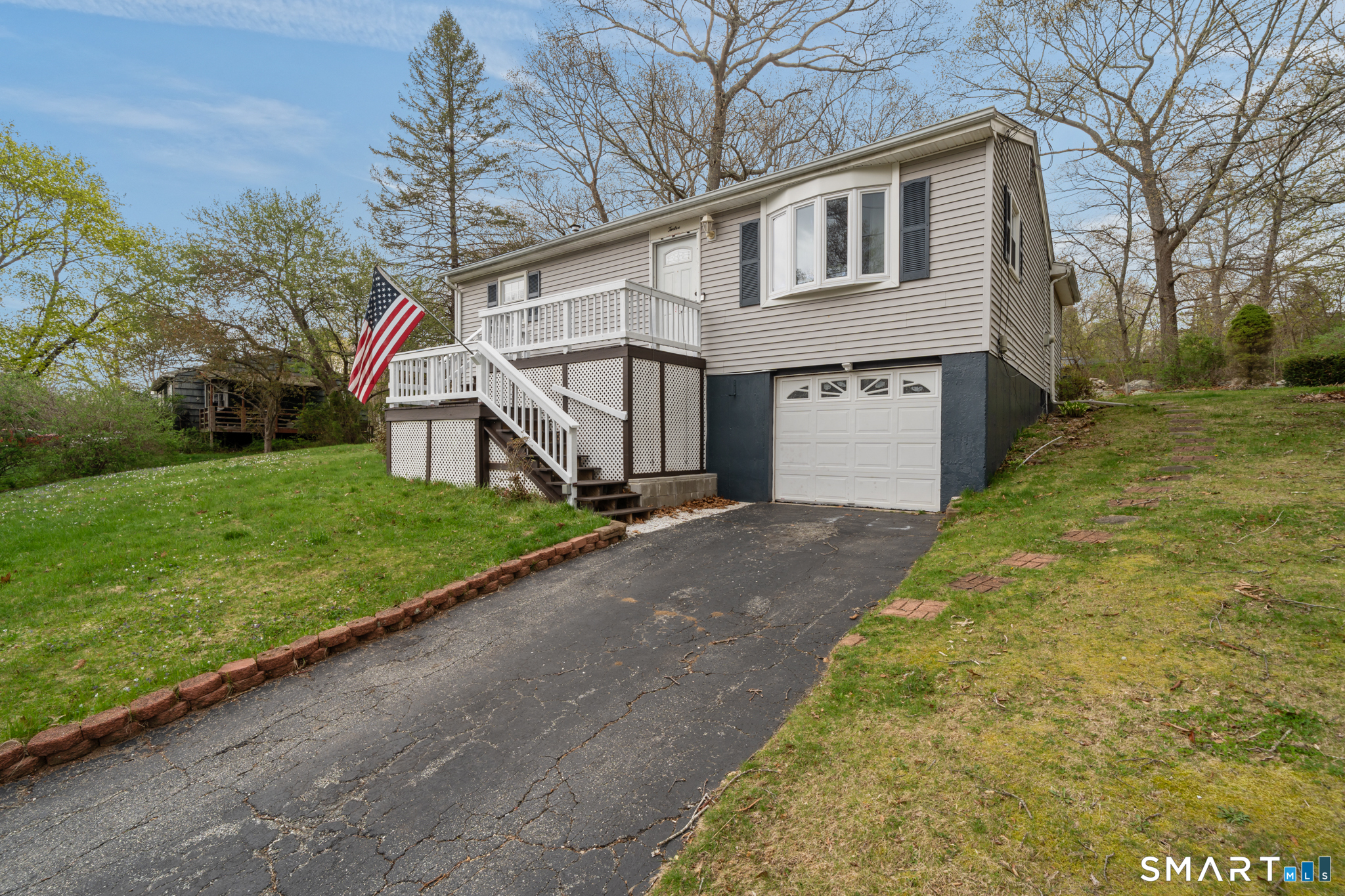 12 Lake Street Ledyard, CT 06339 - Photo 2 of 19 a front view of a house with a yard and garage