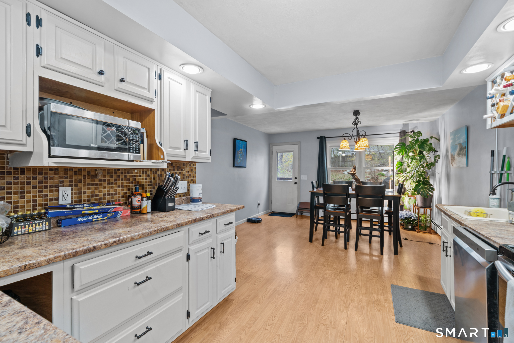 12 Lake Street Ledyard, CT 06339 - Photo 5 of 19 a kitchen with stainless steel appliances granite countertop sink stove refrigerator dining table and chairs