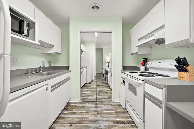 a kitchen with stainless steel appliances granite countertop a sink and stove top oven