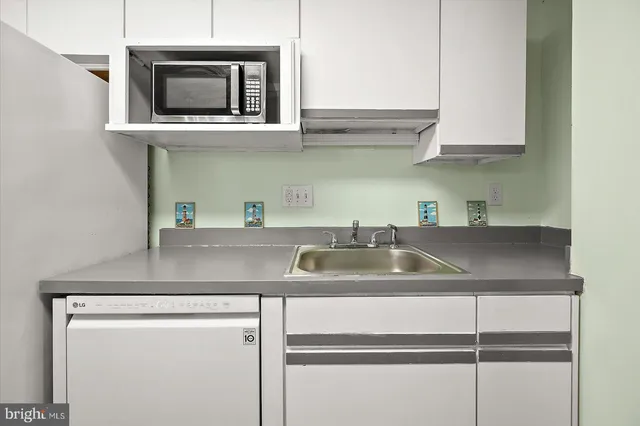 a kitchen with a sink and cabinets