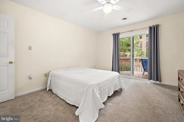a spacious bedroom with a bed and a window