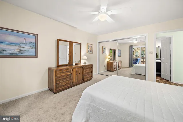 a large bedroom with a large bed and a chandelier