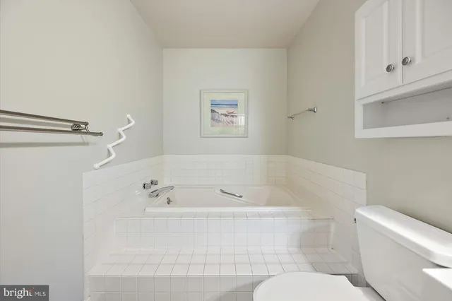 a white bath tub sitting next to a white toilet