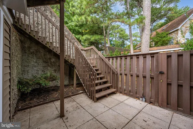 a view of entryway with wooden floor and stairs