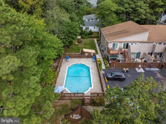 an aerial view of a houses with a lake