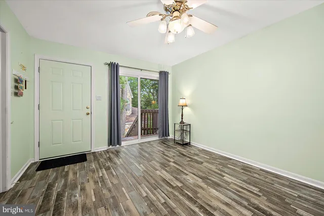 wooden floor in an empty room with a window