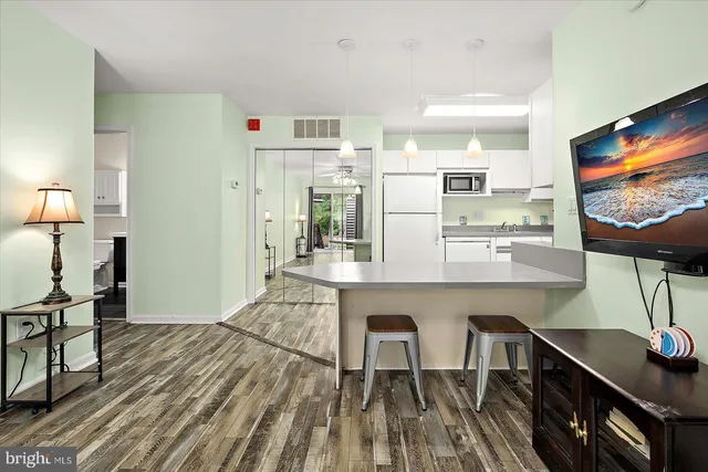 a open kitchen with stainless steel appliances granite countertop a stove and refrigerator
