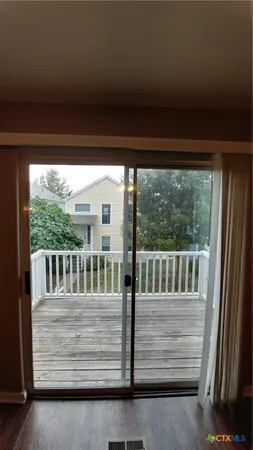 a view of deck with furniture and trees