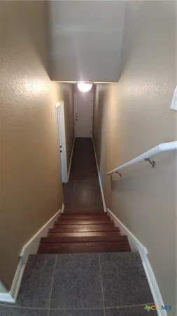 a kitchen with stainless steel appliances wooden floor dining table and chairs