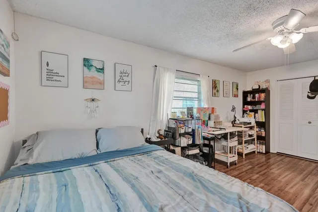 a bedroom with a bed couch and a window