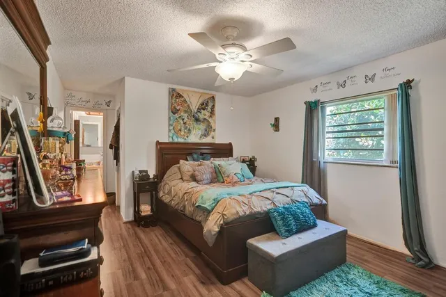 a bedroom with a bed and a mirror on dresser