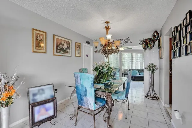 a view of a dining room with furniture and a chandelier
