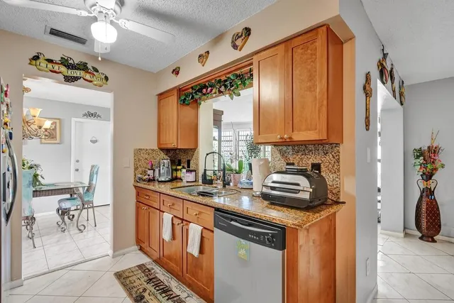 a kitchen with a sink appliances and cabinets