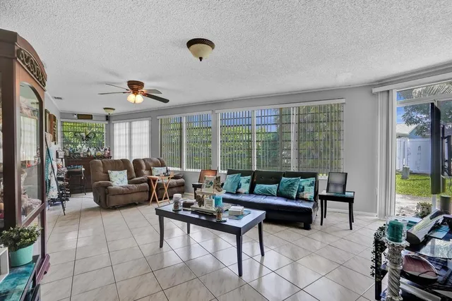 a living room with furniture and floor to ceiling windows