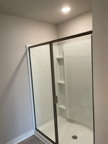 a bathroom with a glass shower door