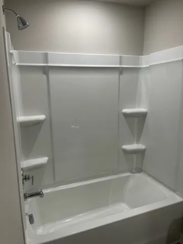 a bathroom with a bathtub and a toilet